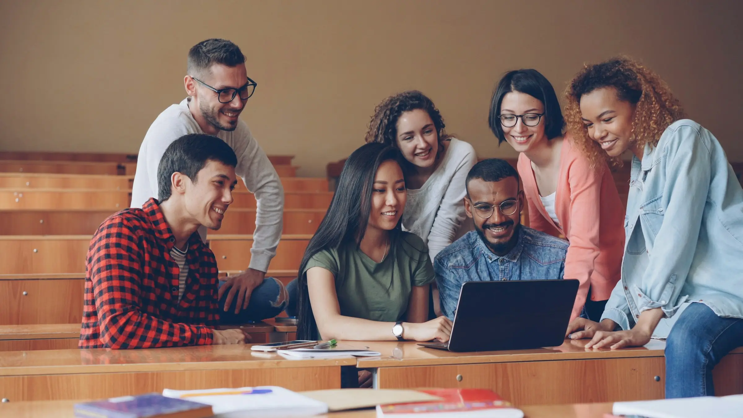 International students working together around a laptop
